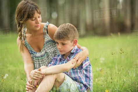 Mother Comforting Son Outdoors Stock Photo Dissolve