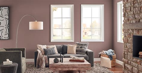Terracotta design build grounds the light walls and drapery with a dark red area rug and gray arm chairs, while the gold accents pop throughout the space. Calming Living Room Ideas and Inspirational Paint Colors | Behr