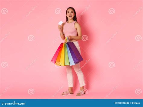 Full Length Portrait Of Upbeat And Excited Smiling Trendy Asian Girl