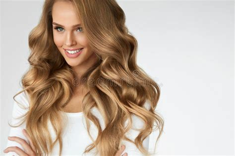 Avoid using a pick on the top layer of your hair or picking through the ends—this will create frizz. Beautiful Curly Hair. Girl With Wavy Long Hair Portrait ...
