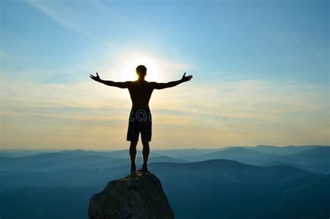 Man Stands On Top Of A Mountain With Open Hands Stock Photo Image Of