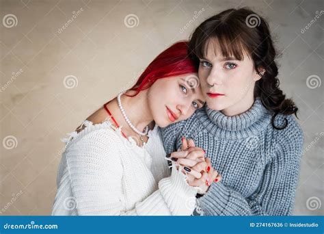 Portrait Of Two Tenderly Hugging Women Dressed In Sweaters Lesbian
