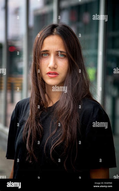 Beautiful Olive Skinned Young Woman With Light Colored Eyes Standing
