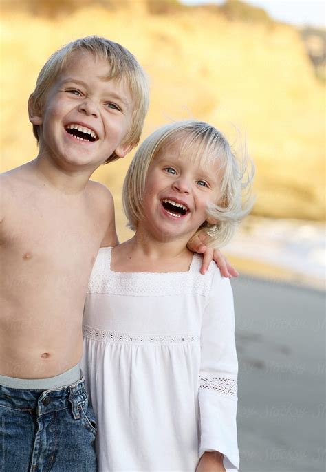 Blonde Boy And Girl Laughing On Beach By Stocksy Contributor Dina