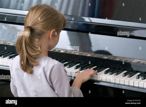 A Young Girl Playing Piano Stock Photo Alamy