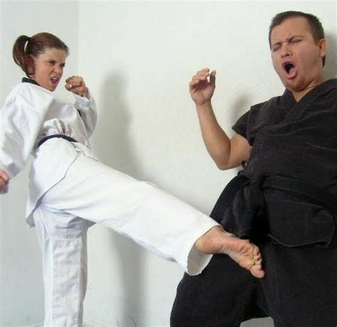 A Man And Woman Doing Karate Moves In The Room