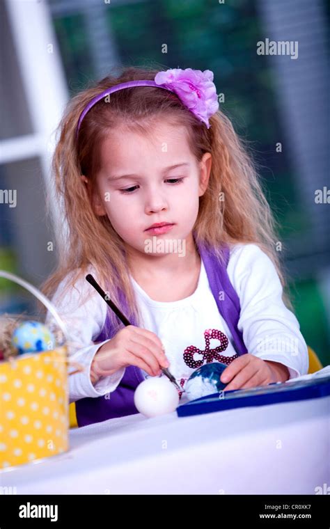 Little Girl Painting Easter Eggs Stock Photo Alamy