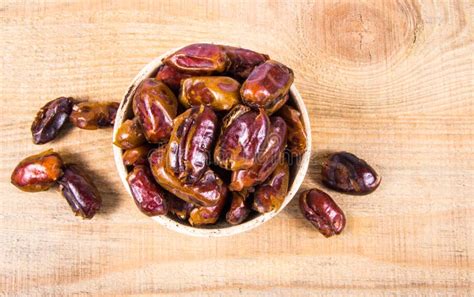 Dry Dates Fruit In The Bowl On The Wood Background Stock Photo