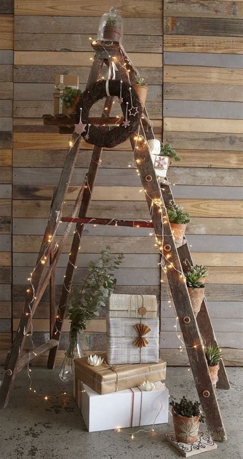 A Christmas Tree Made Out Of Wooden Ladders With Lights And Presents