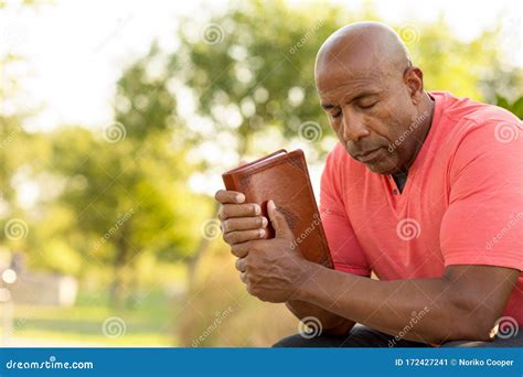 african american man praying and reading the bible stock image image of intercede holding