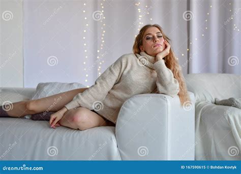 girl lying on sofa in sweaters and socks and in black underwear stock image image of erotic