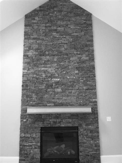 The heating black and stone fireplace. Grey stone fireplace. Floor to ceiling. | Natural stone ...