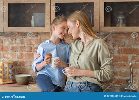 Happy Mother And Daughter Sharing Secrets While Drinking Tea Stock