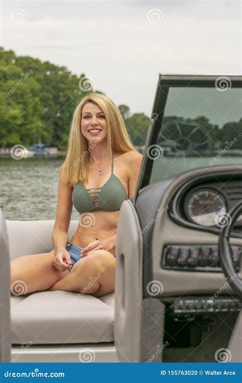 Beautiful Bikini Model Relaxing On A Boat By The Docks Stock Photo Image Of Female Body