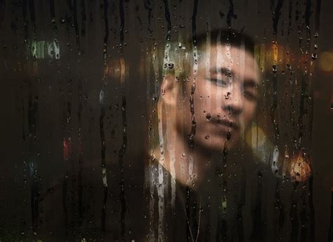 Portrait Of A Man Behind Glass With Raindrops · Free Stock Photo