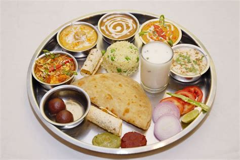 try out our authentic punjabi thali consisting of vegetables dal kadhi parathas pulao lassi