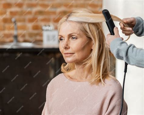 Free Photo Mature Woman Getting Her Hair Straightened By Hairdresser At Home