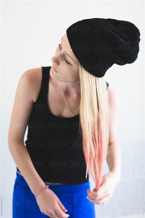 Teenage Girl Putting Pink Hair Day On The Tips Of Her Long Blonde Hair