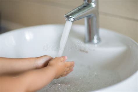Hygiene Concept Kid Washing Hands With Soap Under The Faucet With