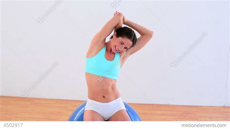 Fit Brunette Stretching On An Exercise Ball Stock Video Footage