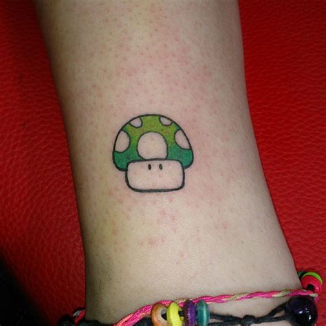 Mario mushroom tattoos on heel. Dreadful Green Ink Mario Mushroom Tattoo - Tattoo Maze