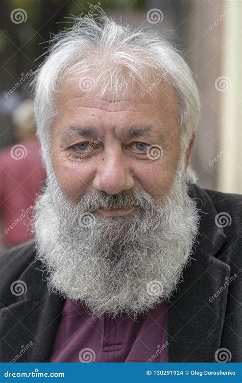 portrait of old man with a gray beard in a russian orthodox church in the center of tbilisi