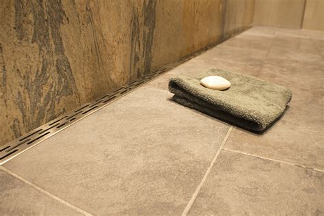 Plank pitch allows for large format tile or stone to be used on the shower floor. Noble Company FreeStyle Linear Drain with a Slotted ...