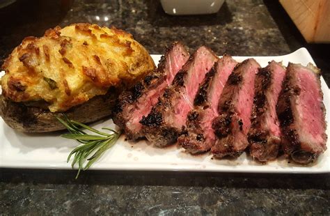 Place the cubed steak into an appropriate sized baking dish which you have sprayed with cover with foil. Homemade Grilled Steak with Twice Baked Potato : food