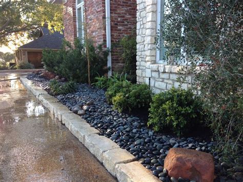 Water thoroughly immediately after planting, and make sure to water regularly on an ongoing basis. Here we used river rock instead of mulch. Makes for a ...