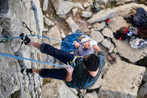 A Climber Descending With The Rope After Climbing A Rock Wall Stock