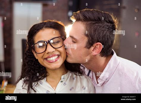 Man Kissing Woman On Cheek Stock Photo Alamy