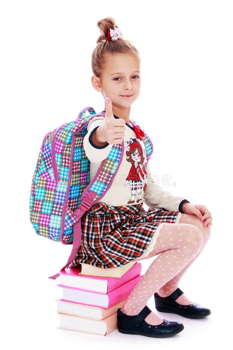 Girl Schoolgirl Sitting On A Stack Of Books Behind Stock Image Image