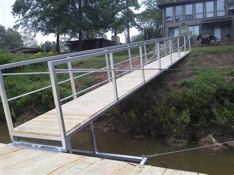 Steel gangway connected to a floating boathouse. Genesis Services - OUR Types of Docks, Ramps, and Accessories: