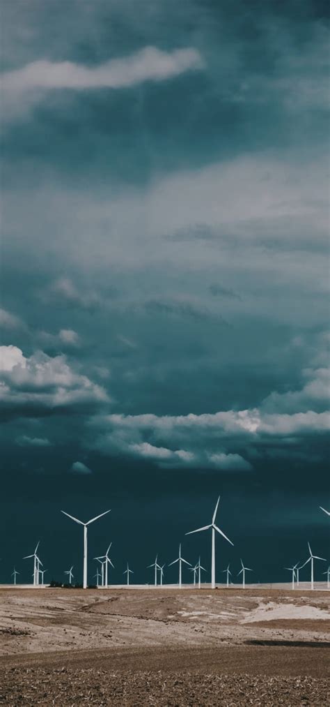 Download 1080x2310 Wind Turbine Dark Clouds Field Energy Wallpapers