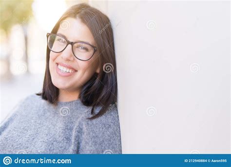 Beautiful Young Woman Wearing Glasses Smiling Cheerful Leaning On Wall
