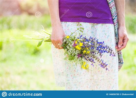 The Girl Is Holding A Bouquet Of Wildflowers Stock Image Image Of Clear Blue 146856785