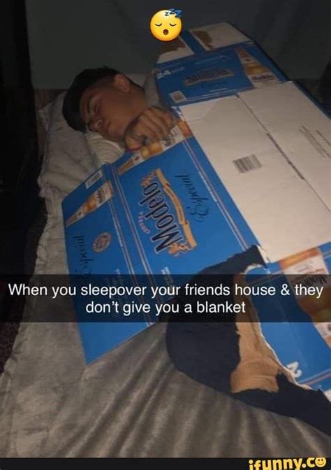 A Man Laying On Top Of A Bed Next To Boxes