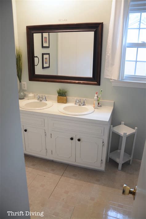 This bathroom vanity requires some thick pieces of plywood, wood boards, a large mirror, and vessel sinks. BEFORE & AFTER: My Pretty Painted Bathroom Vanity