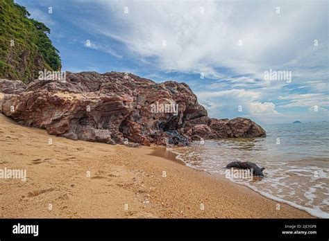 Sea Side Landscape With Rock Formations And Vegetation Clad Rocky Cliffs At The Beach Of Pantai