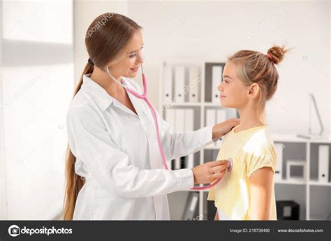 Female Doctor Examining Little Girl Clinic Stock Photo By ©serezniy