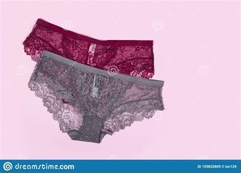 beautiful lace lingerie on a pink isolated background gray and burgundy classic briefs stock
