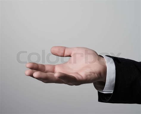 Man Holding Something In His Hand Stock Image Colourbox