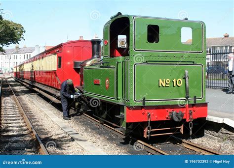 Historic Steam Locomotive With Passenger Wagons On Rail Tracks
