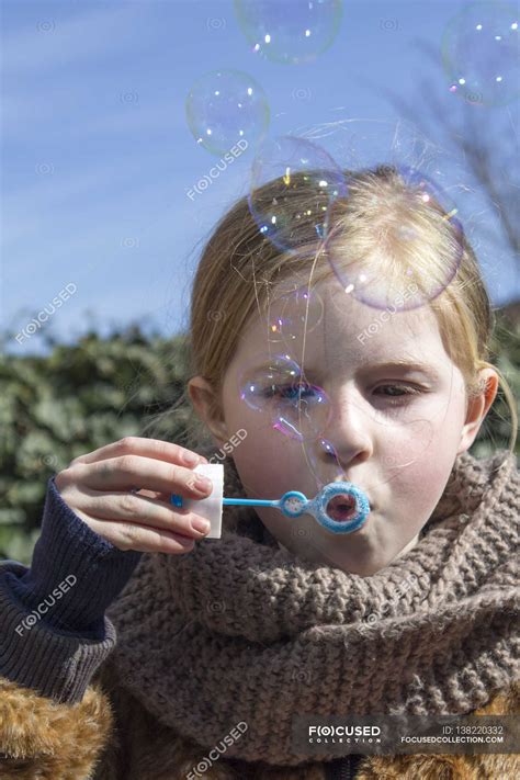 Girl Blowing Bubbles — Concentration Outdoors Stock Photo 138220332