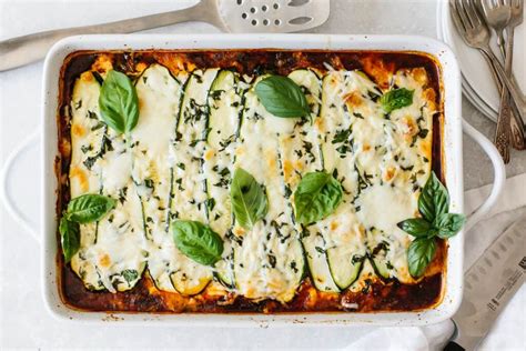 Zucchini Lasagna In A White Casserole Dish With Basil Leaves On Top