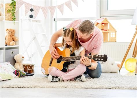 Premium Photo Father Playing Guitar With Cute Daughter