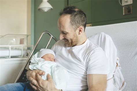 Father With Her Newborn Baby At The Hospital A Day After Birth Stock