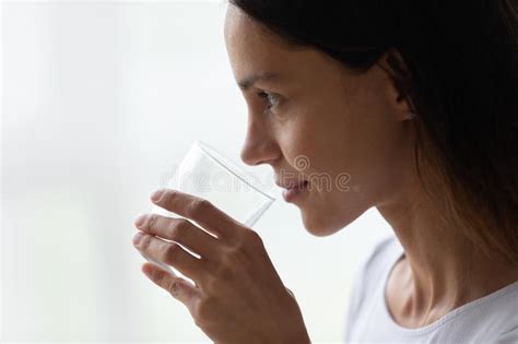 Closeup Face Of Beautiful 30s Woman Holds Glass Of Water Stock Image