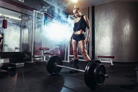 fitness blonde girl prepares for exercising with barbell in gym stock image image of athlete