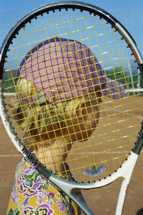 Girl Holding Tennis Racket Looking At Tennis Court Stock Photo Dissolve